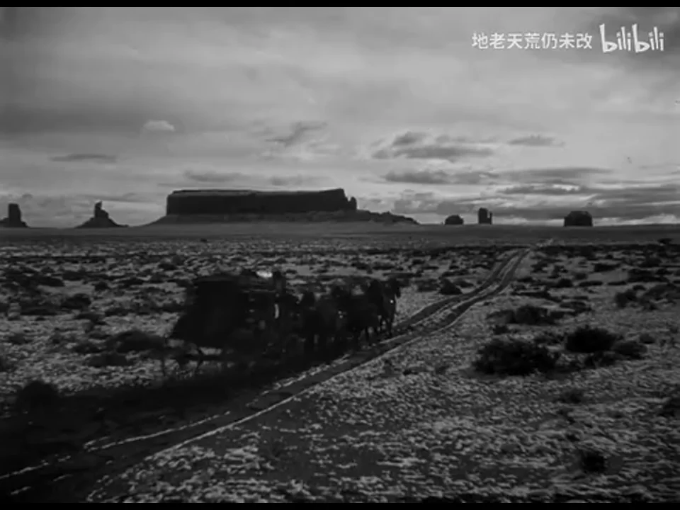 驿车和马匹位于开阔谷地左下方，远处台地与天空占据大部分画面。